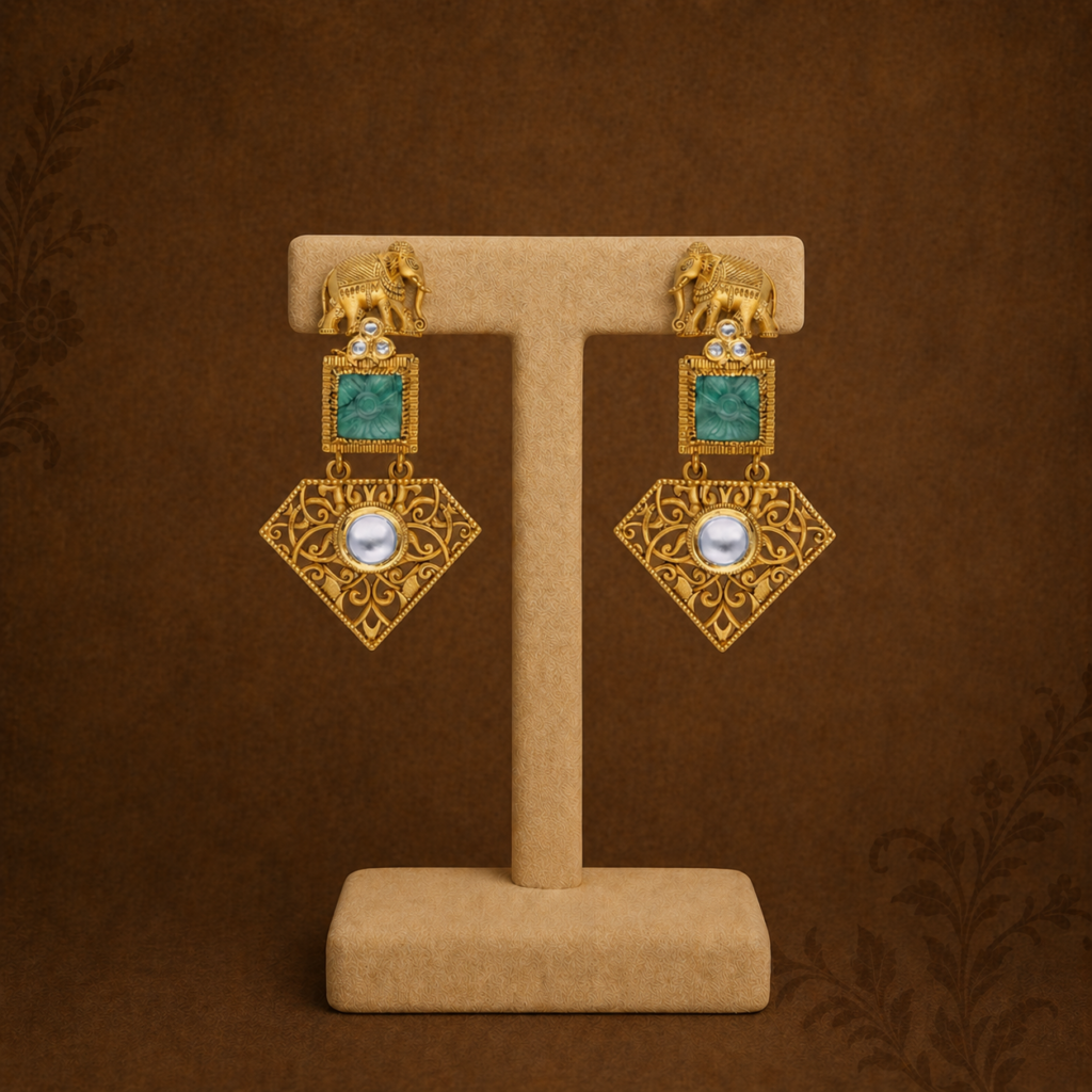 Deccan Collection gold earrings with emerald stones, elephant motifs and intricate filigree detailing