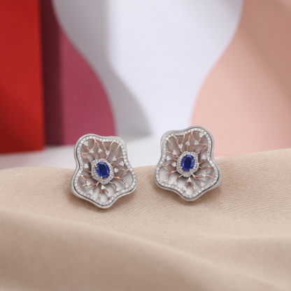 Blue sapphire titanium stud earrings with diamond accents, floral designer earrings, contemporary luxury titanium jewellery.