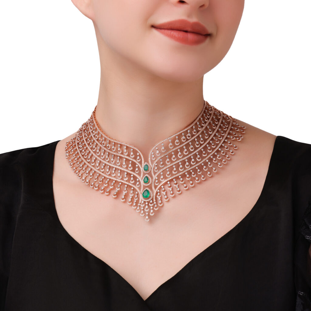 Diamond and emerald necklace featuring an elaborate layered design with pear-shaped diamond drops and vivid green emerald accents.