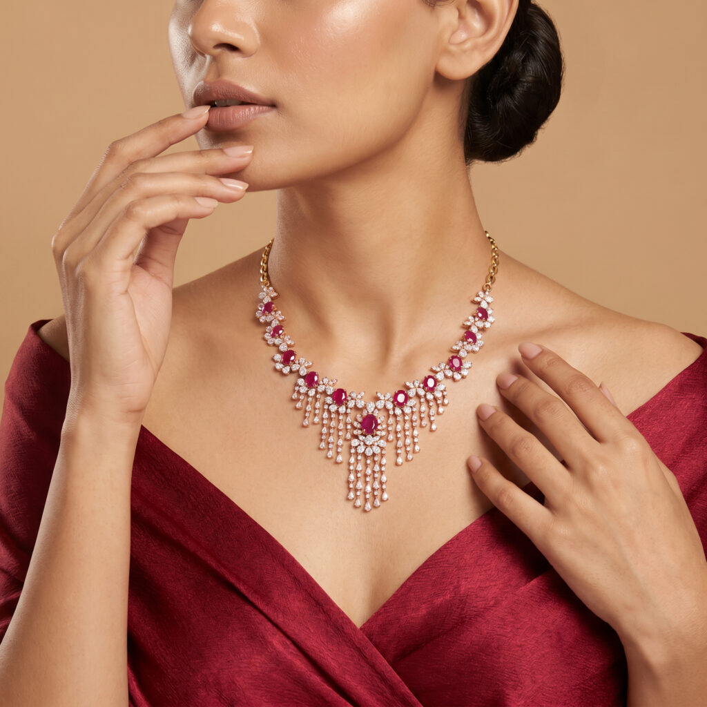 Ruby and diamond necklace featuring vivid red rubies, brilliant diamonds and an elegant floral drop design in gold.
