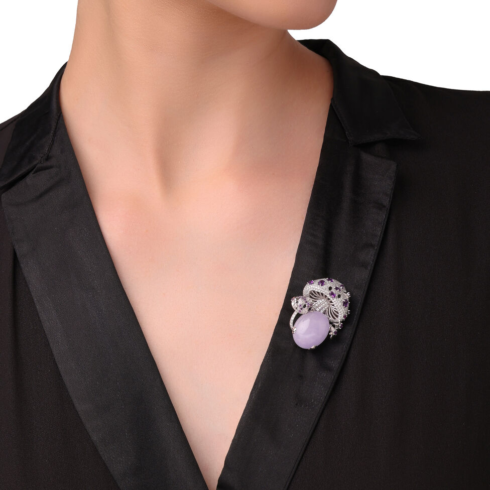 Lilac coloured gemstone brooch with diamonds on a black lapel