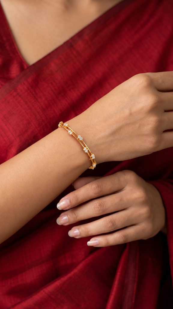 C. Krishniah Chetty delicate gold bracelet styled elegantly with a red saree
